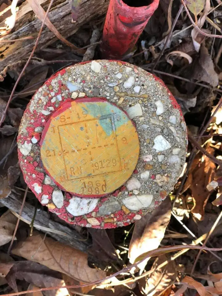 Old government survey disc marking a section corner